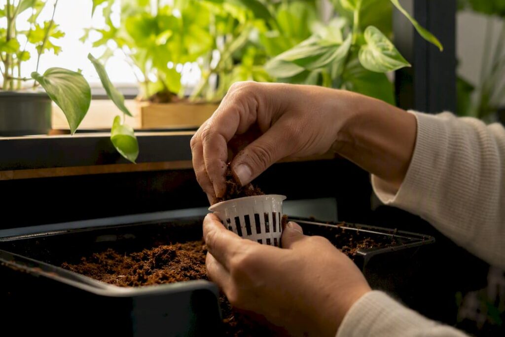 Hands assembling grow pod core components